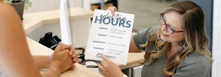 Chiropractic Bellingham WA Contact Us The receptionist at Connect Family Chiropractic helping a patient check in